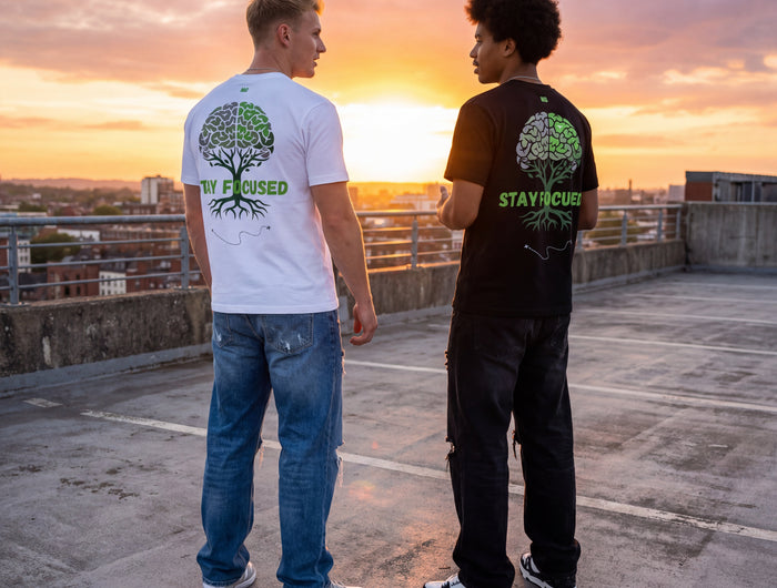 2 man wearing the MoGrosso Stay Focused T-shirt in black and white on a rooftop with a nice sunset talking to each other