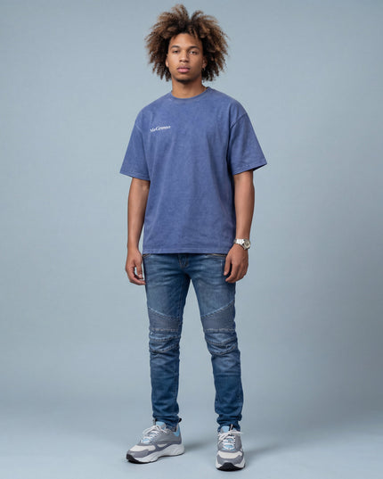 man wearing the MoGrosso blue Vintage Oversized T-shirt on a grey background with a clean outfit